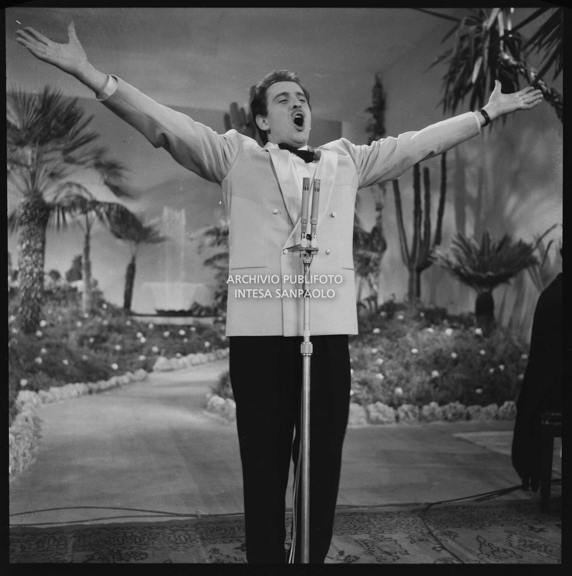 Domenico Modugno in the famous performance of the song "Nel blu dipinto di blu" on stage at the 8th Sanremo Festival