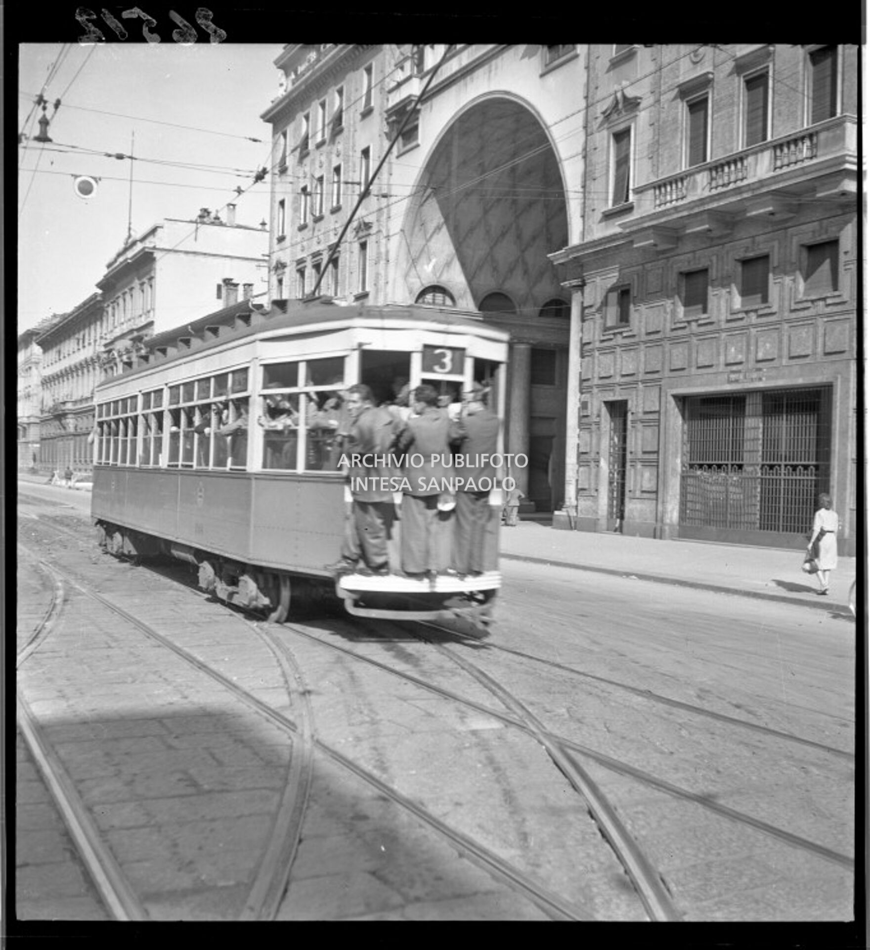Tram tipo 1928, linea 3, in transito in corso Venezia a Milano; la vettura è così affollata che alcuni passeggeri viaggiano in piedi sul paraurti posteriore (dipinto di bianco per aumentarne la visibilità durante l'oscuramento)