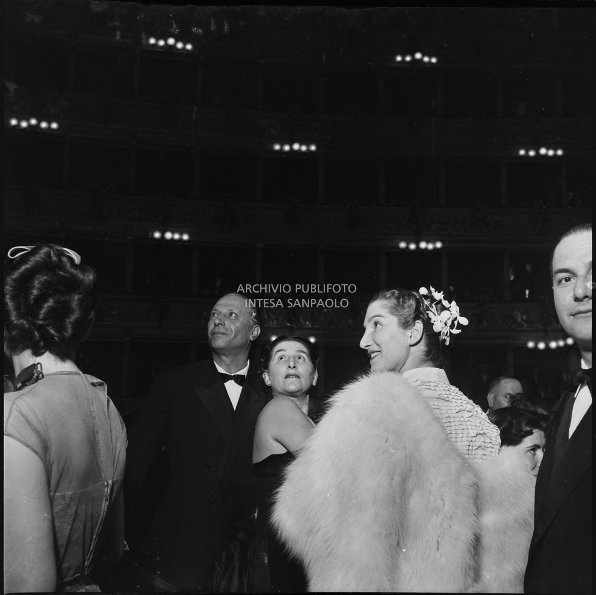 Spettatori in platea rivolgono lo sguardo verso i palchi la sera dell'inaugurazione della stagione lirica 1951-1952 del Teatro alla Scala con l'opera "I vespri siciliani" di Giuseppe Verdi, diretta da Victor de Sabata, con la regia di Herbert Graf