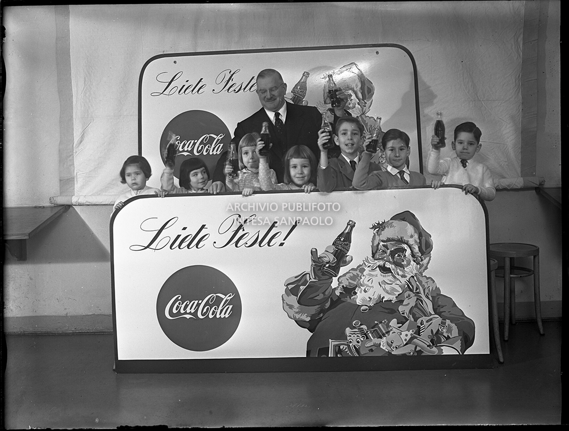 A Coca-Cola manager with a group of children on the advertising campaign set in Milan