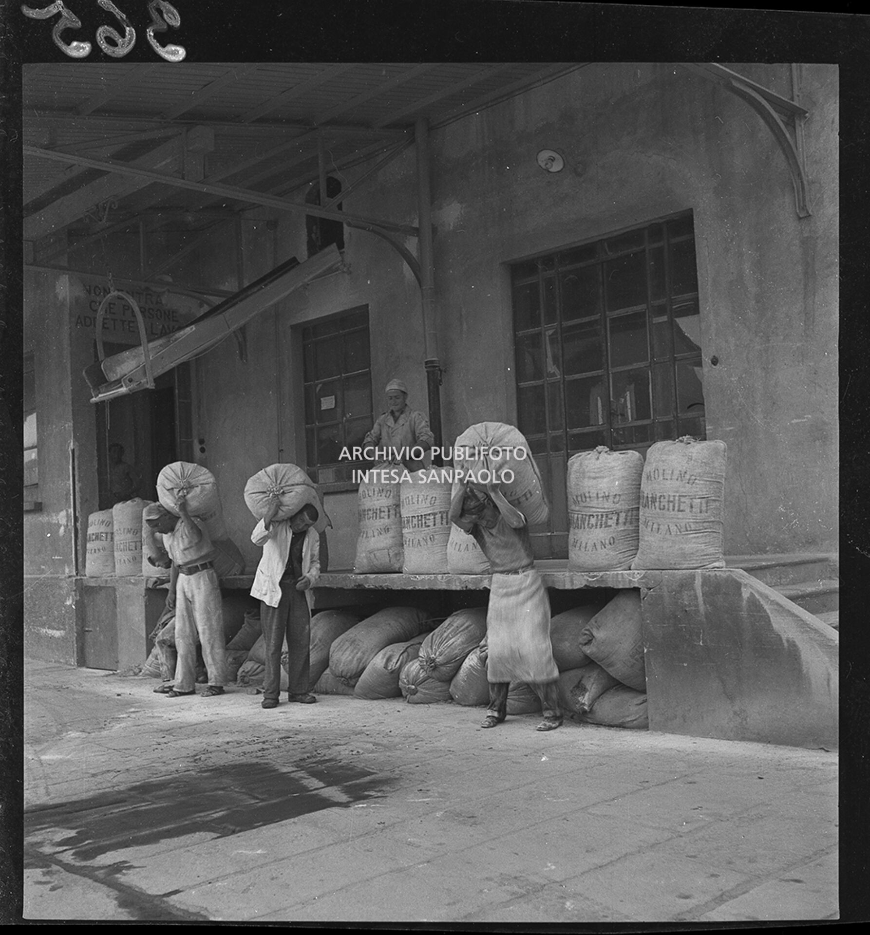 Unloading of flour sacks, sent by Allied Forces to help the local population