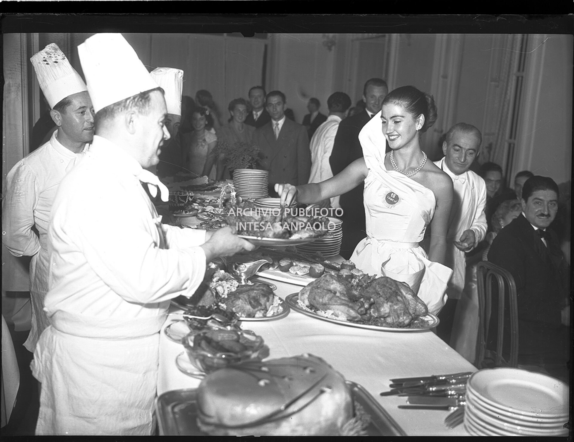 Mariella Giampieri, Miss Italia 1949, at a buffet in Stresa