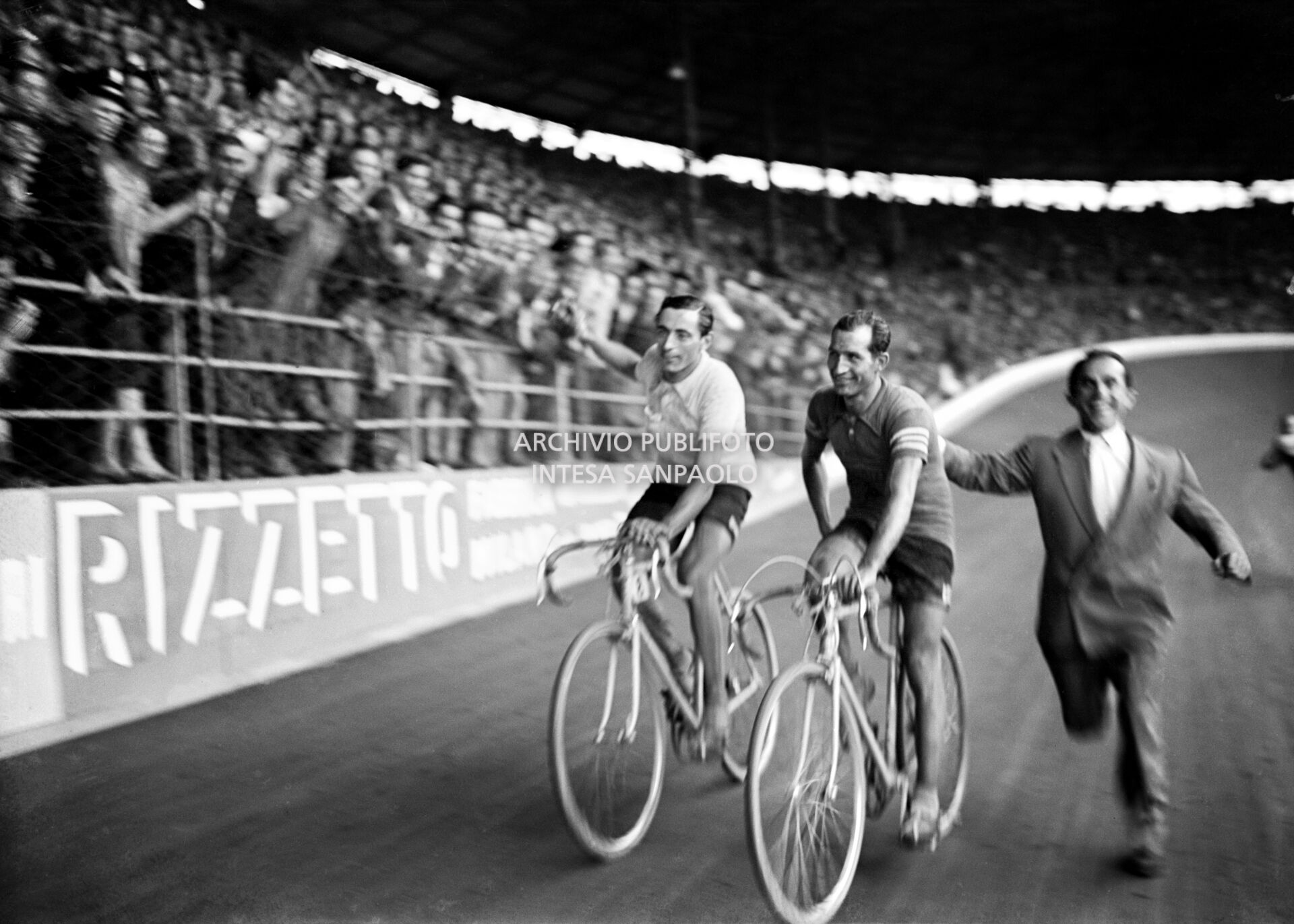 Fausto Coppi wins the 30° Giro d'Italia and completes a lap of honour with Gino Bartali at the Vigorelli velodrome of Milan