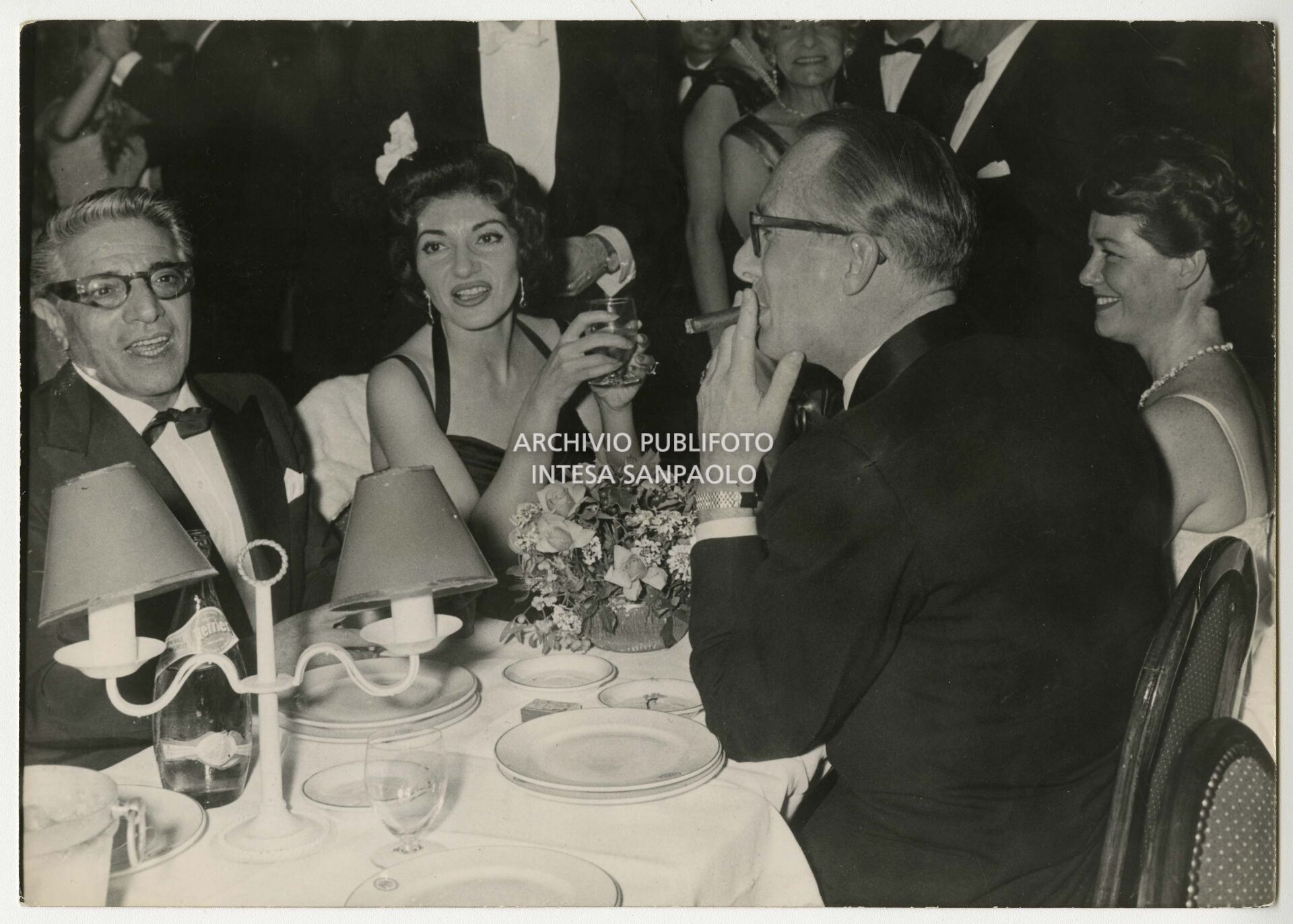 Maria Callas and Aristotele Onassis dining with the Duke and Duchess of Bedford at New Year's Eve party at the Hôtel de Paris