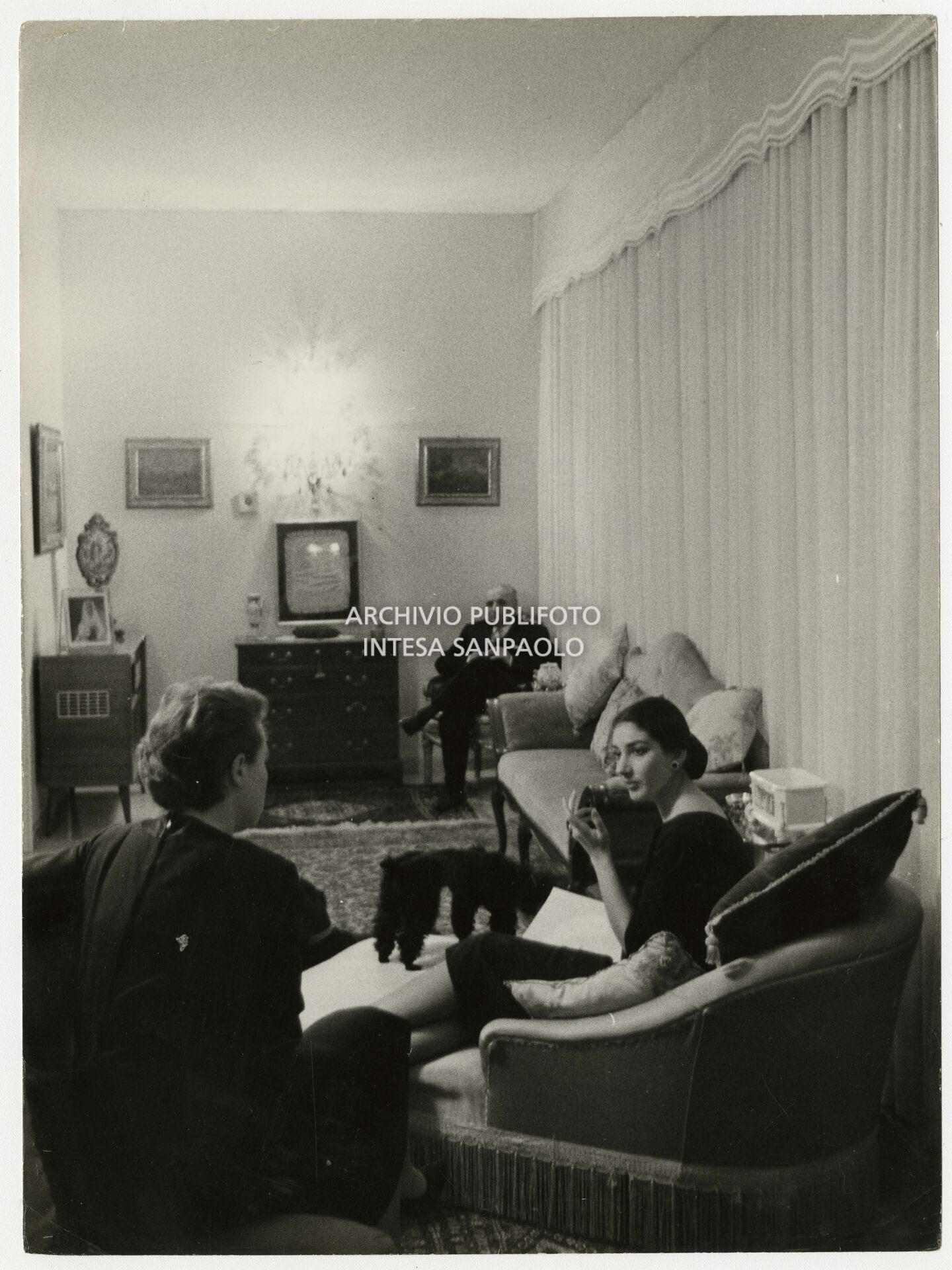 Maria Callas at home in the company of her husband and her secretary