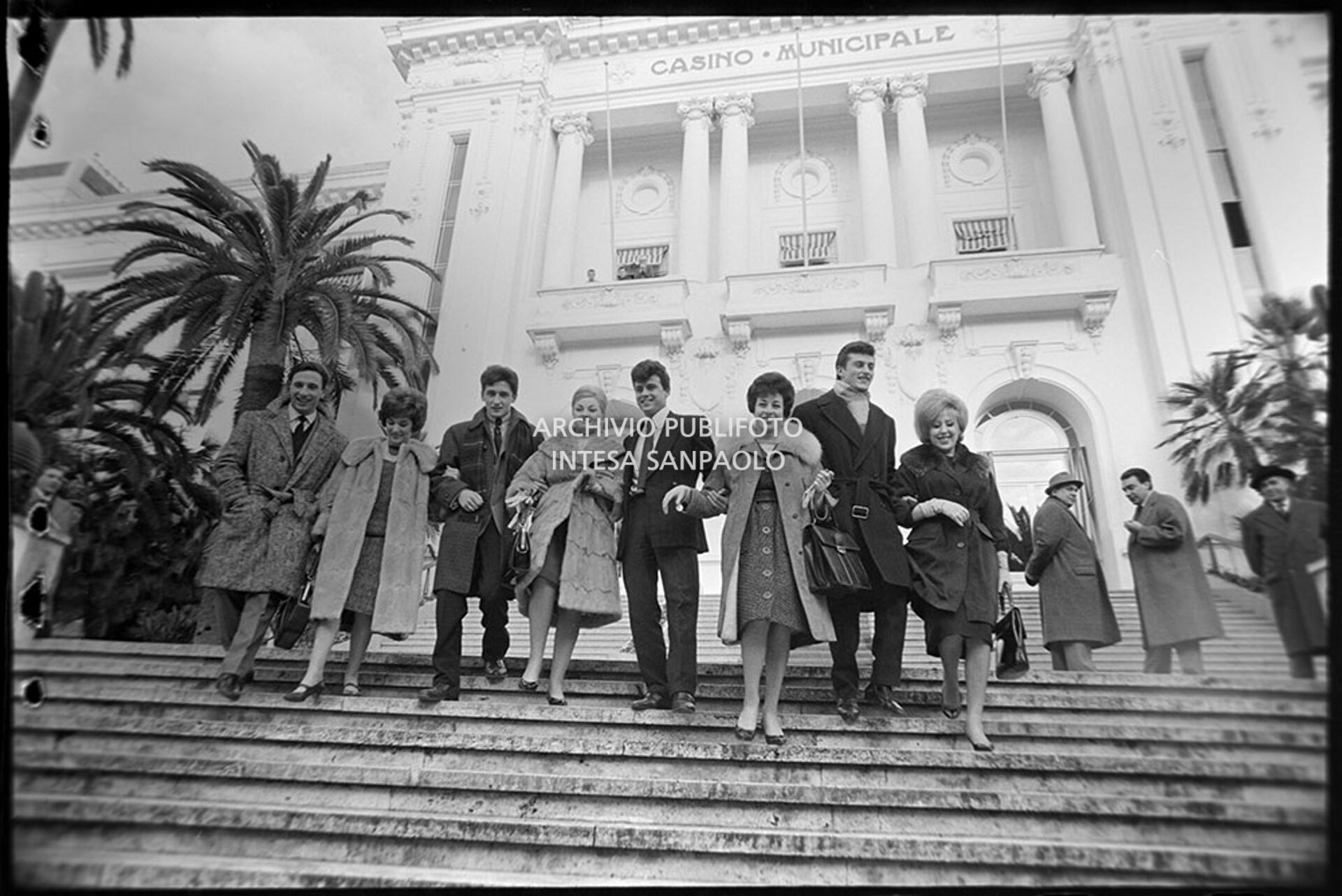 Group photo on the Casino steps during the 11th Sanremo Festival: from left Rocco Granata, Jolanda Rossin, Pino Donaggio, Silvia Guidi, Little Tony, Nadia Liani, Tony Renis and Betty Curtis