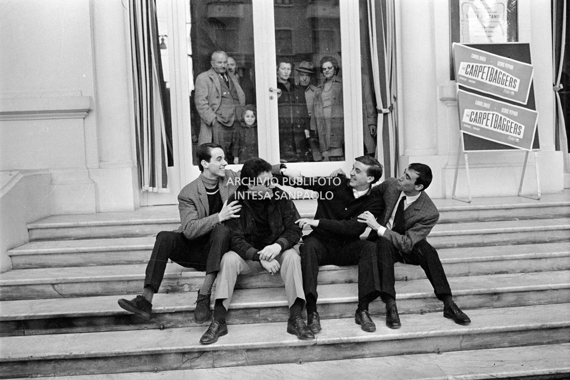 Don Miko, Gianni Mascolo, Giordano Colombo and Vittorio Inzaina (left to right) seated on the steps of the Casino at the 15th Sanremo Festival
